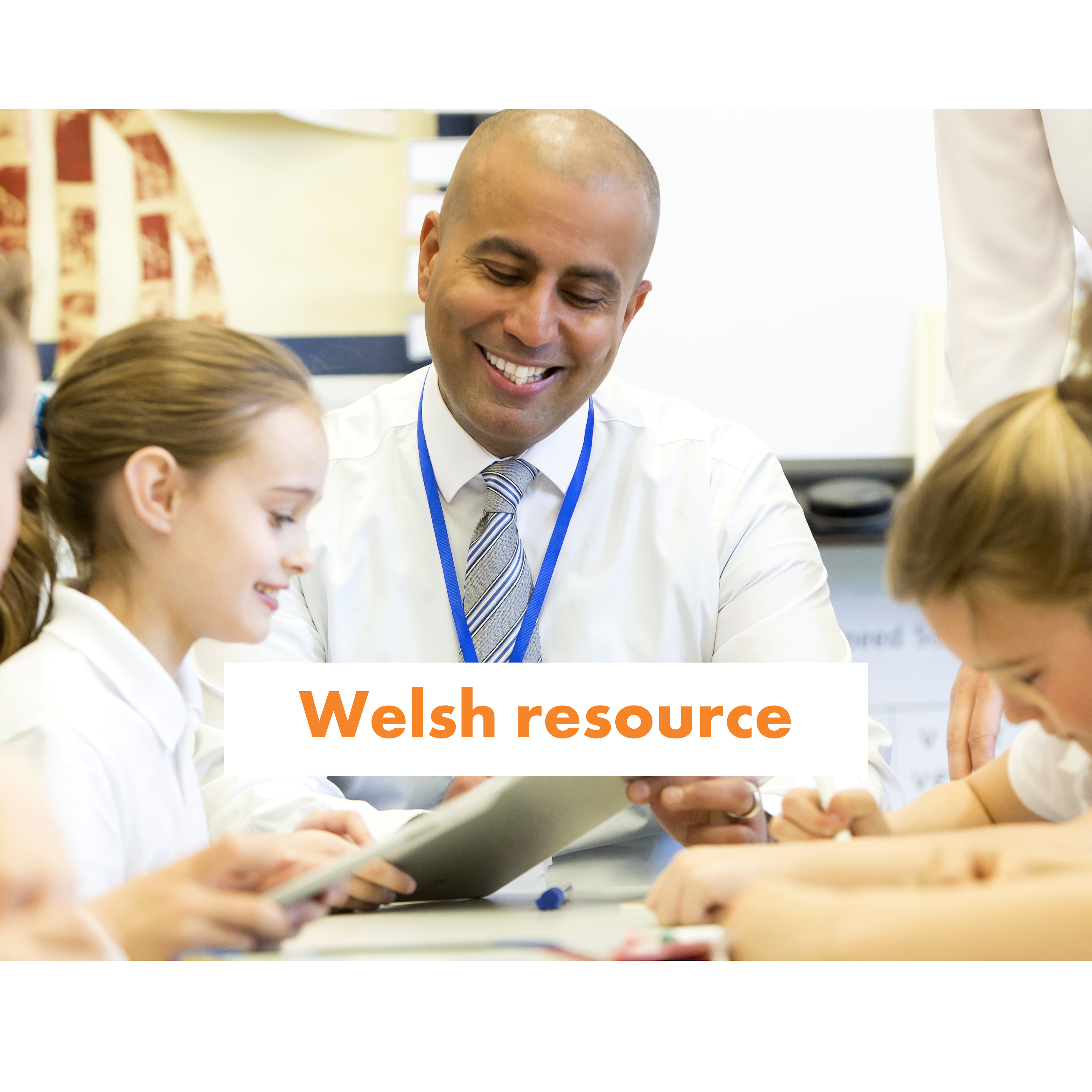 A smiling teachers shows pupils a tablet screen.