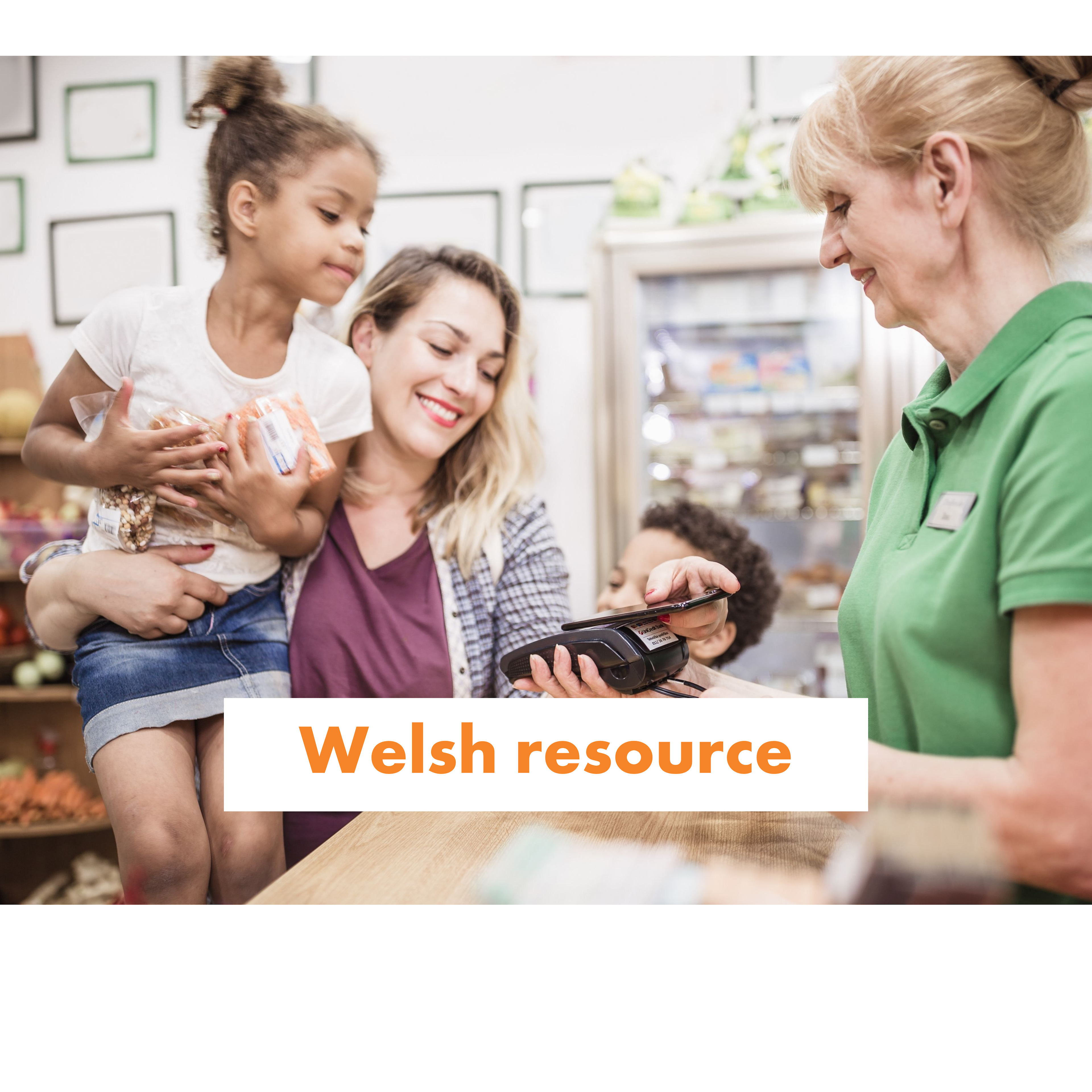 A mother and daughter pay a shop keeper using a card machine.